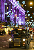 England, London, Soho, Oxford Street, Chirstmas decorations and London taxi.