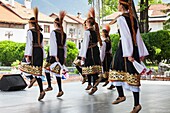 Bulgaria, Southern Mountains, Bansko, ski resort, people in local ethnic costumes, NR.
