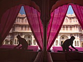 Silhouette of men working in front of Hawa Mahal, Jaipur, Rajasthan, India