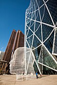 'The Bow, office building in Calgary, Alberta, Canada. Design by Norman Foster, architect. ''Wonderland'', sculpture by Jaume Plensa.'