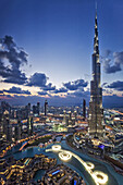 View from above of the Burj Khalifa (Armani Hotel) designed by Skidmore Owings and Merrill , the Souk Al Bahar and the Dubai Fountains at twilight, Business Bay, Dubai, The United Arab Emirates.