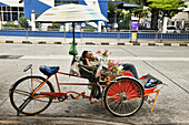 sleeping in a becak (trishaw) in Georgetown in Penang, Malaysia.