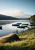 boats at Lake Eder while morning mist disappears, National Park Kellerwald-Edersee, Hesse, Germany