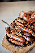 deep fried Nuremberg sausages served on wooden plate, Nuremberg, Frankonia Region, Bavaria, Germany