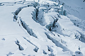 Three young winter sportspersons making a ski tour through the deep powder snow, Pitztal, Tyrol, Austria