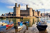 Caernarfon or Carnarvon or Caernarvon, Gwynedd, Wales, United Kingdom. Caernarfon Castle seen across the River Seiont. It is part of the UNESCO World Heritage Site which includes a group of Castles and Town Walls of King Edward in Gwynedd. Harlech and Bea