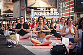 Thousands of yoga practitioners pack Times Square in New York to participate in a Power Yoga class on the first day of summer. The 12th annual Solstice in Times Square, ´´Mind Over Madness´´, stretches the yogis´ ability to block out the noise and the vis