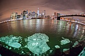 The New York skyline is seen across the East River from Brooklyn.Chunks of ice floating in the river due to the cold weather has caused the ferry service to be suspended on Tuesday. The East River boats are smaller than the one used on the Hudson River an