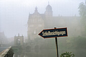 Castle in fog, castle tour, entrance sign for visitors, Hämelschenburg, Lower Saxony, northern Germany