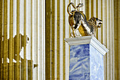 Golden statue of lion in front of pillars, Antikensammlung, Munich, Upper Bavaria, Bavaria, Germany