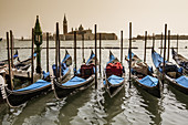 Venetian Gondolas and San Giorgio Maggiore island. San Marco district, Venice, Veneto region, Italy, Europe.