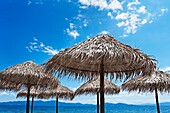Parasols on beach against blue sky on Pelion Peninsula, Thessaly, Greece