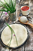 Basic Dough for pizza made with tomatoes, chives and mozzarella.