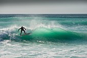 A surfer at Fistral in Newquay, Cornwall.
