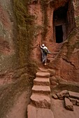 Woman on stairs at Bet (or Biete) Ammanuel ( House of Emmanuel). Rock Hewn Churche of Lalibela. Ethiopia.