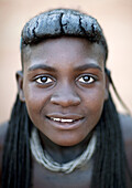 Mucawana girl with traditional hairstyle, village of Oncocua, Angola.