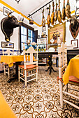 A typical traditional restaurant with ham and decorations in the historical centre, Seville, Andalusia, province Seville, Spain