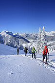Four persons back-country skiing ascending to Trainsjoch, Mangfall range in background, Trainsjoch, Bavarian Alps, Upper Bavaria, Bavaria, Germany
