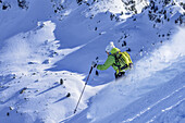 Woman downhill skiing from Gamskopf through deep snow in the back-country, Gamskopf, Kitzbuehel Alps, Tyrol, Austria