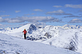 Frau auf Skitour steigt zum Falkert auf, Großer und Kleiner Rosennock im Hintergrund, Falkert, Nockberge, Biosphärenpark Nockberge, Kärnten, Österreich