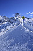 Woman back-country skiing ascending to Kampl, Bischofsmuetze in background, Kampl, Gosau range, Dachstein, Salzburg, Austria