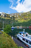 Flam Norway small beautiful village on lake with ferries and boats deep in mountaions at peaceful setting for holiday drive between Oslo an dBergen.