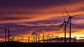 Silhouetted wind turbines at sunset, Mojave, California USA.