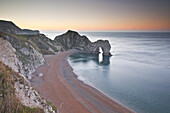The morning light across Durdle Door on the Jurassic Coastline in Dorset.