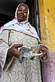 woman whith little cayman in elephantine island. asuan.