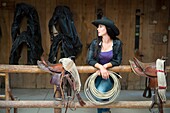 Cowgirl (Wrangler) with lasso standing at Averill´s Flathead Lake Lodge, a dude ranch near Kalispell, Montana, United States.