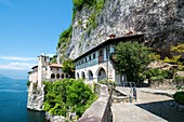 Eremo di Santa Caterina del Sasso and lake Maggiore with mountain in a sunny day in Lombardy, Italy.