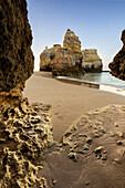 A sea cave frames the ocean and the imposing cliffs at dawn, Praia da Rocha, Portimao, Faro district, Algarve, Portugal, Europe