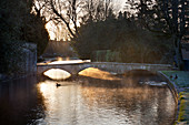 Cotswold stone bridge over River Windrush in mist, Bourton-on-the-Water, Cotswolds, Gloucestershire, England, United Kingdom, Europe