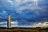 'Lighthouse known as Malarrif on the Snaefellsness Peninsula with rain squall falling in the background; Iceland'