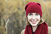 'A beautiful young woman posing for the camera during an outing in a city park in autumn; Edmonton, Alberta, Canada'