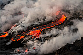 'Flowing lava and steam on a hawaiian island; Island of Hawaii, Hawaii, United States of America'