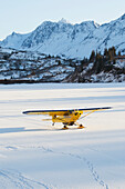 Piper PA-18 Super Cub on skis with the Kenai Mountains in the background, Southcentral Alaska.