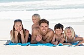 Portrait of a happy family lying on the beach