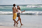 Happy young couple enjoying on the beach