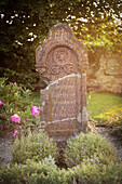 grave in cemetery of Stephanus church at deserted village Gruorn, former military area, Muensingen, Reutlingen district, Swabian Alb, Baden-Wuerttemberg, Germany