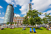 Tourists and locals relaxing in front of the hotel New York, the former main building Holland America line, Rotterdam, Netherlands