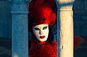 Mask between columns on Paglia Bridge. Venice, Veneto, Italy.