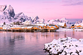 The colors of dawn frames the fishermen houses surrounded by snowy peaks Sakris?©y Reine Nordland Lofoten Islands Norway Europe