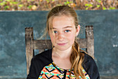 Caucasian girl sitting in chair