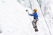 A girl ice climbing on the Kid's Wall during the Ouray Ice Festival, Ouray Ice Park, Ouray, Colorado.