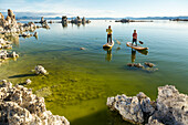 A woman and her daughter stand up paddleboarding on Mono Lake from South Tufa Beach, Lee Vining, California.