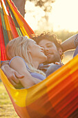 Couple relaxing together in hammock