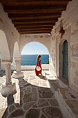 Woman near the columns of the main church in Parikia, Paros, Cyclades Islands, Greek Islands, Greece, Europe.