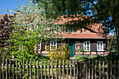 Farmhouse, holiday house with flowering garden in spring in Brandenburg, museum village Baruth Glashuette, Brandenburg, Germany