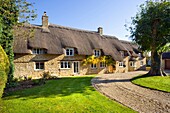 An idyllic thatched cottage at Bampton on the edge of the Cotswolds, Oxfordshire, UK.